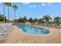 Inviting private pool surrounded by brick pavers, lounge chairs, and lush landscaping at 3009 Banyan Hill Ln, Land O Lakes, FL 34639