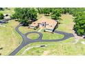 Expansive property with a large home, circular driveway, and lush green landscape at 30723 Reed Rd, Dade City, FL 33523