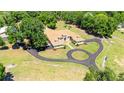 Expansive property featuring a well-maintained home, lush landscaping, and a circular driveway for easy access at 30723 Reed Rd, Dade City, FL 33523