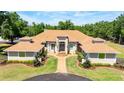 Beautiful front facade with manicured landscaping and charming walkway leading to the grand entrance at 30723 Reed Rd, Dade City, FL 33523