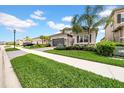 Beautiful home with lush green lawn, palm trees, and manicured landscaping at 3096 Great Banyan Way, Wesley Chapel, FL 33543