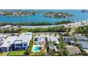 Stunning aerial view of home with pool and bay views, ideal for waterfront living at 3210 E Maritana Dr, St Pete Beach, FL 33706