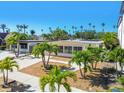 Beautiful home exterior with palm trees and walkways to front entry at 3210 E Maritana Dr, St Pete Beach, FL 33706