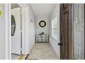 Inviting home foyer featuring neutral paint, tiled floors, and coat hooks at 3210 E Maritana Dr, St Pete Beach, FL 33706