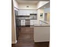 Bright kitchen featuring stainless steel appliances, granite countertops, and white cabinets at 402 S Armenia Ave # 127, Tampa, FL 33609