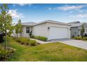 Inviting single-story home with a well-maintained lawn and a convenient two-car garage at 44239 Frontier Dr, Punta Gorda, FL 33982