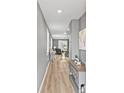 Welcoming home hallway with wood flooring, leading to a living area and filled with natural light at 44239 Frontier Dr, Punta Gorda, FL 33982