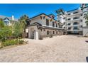 Beautiful exterior elevation showcasing the brick driveway, two-story design, and pristine landscaping at 455 Pinellas Bayway S # 3B, Tierra Verde, FL 33715