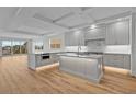 A modern, spacious kitchen featuring gray cabinetry, stainless steel appliances, and a large center island at 455 Pinellas Bayway S # 3B, Tierra Verde, FL 33715
