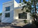 Modern, two-story home with a stucco facade and large windows for ample natural light at 4716 W Lawn Ave, Tampa, FL 33611