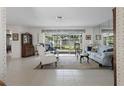 Bright living room with neutral tiled floors, comfortable seating and large windows to enjoy the backyard view at 5053 43Rd S St, St Petersburg, FL 33711