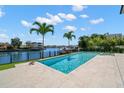 Inviting pool with canal views, surrounded by a spacious deck, perfect for relaxing or entertaining guests outdoors at 5142 W San Jose St, Tampa, FL 33629