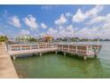 View from the community dock showing benches and views of the water and other condo buildings at 5575 Gulf Blvd # 329, St Pete Beach, FL 33706