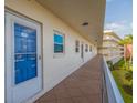 Hallway view with unit door, leading to a private residence in the building's community at 5575 Gulf Blvd # 329, St Pete Beach, FL 33706