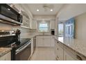 Updated kitchen featuring white cabinets, granite countertops and stainless steel appliances at 5575 Gulf Blvd # 329, St Pete Beach, FL 33706