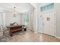 Bright dining area features a rustic wood table, chandelier, and stylish tile flooring at 7207 Forest Mere Dr, Riverview, FL 33578