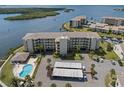Aerial view of waterfront condominium community with pool, covered parking, and stunning water views at 8141 Aquila St # 342, Port Richey, FL 34668