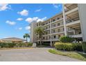 Exterior shows a multi-level condominium building with balconies, palm trees, and well-manicured landscaping at 8141 Aquila St # 342, Port Richey, FL 34668