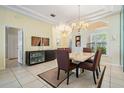 Elegant dining room boasts a modern chandelier, stylish furnishings, and natural light at 10510 Castleford Way, Tampa, FL 33626
