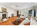 Bright living room with hardwood floors, fireplace, and plenty of natural light at 11383 Pickford St, Spring Hill, FL 34609