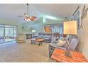 Spacious living room with vaulted ceilings, fan, fireplace, with plush seating and view of backyard at 1239 Tuxford Dr, Brandon, FL 33511