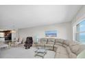 Bright living room featuring a neutral color scheme, a comfortable sectional sofa, and beautiful water views at 1270 Gulf Blvd # 1904, Clearwater Beach, FL 33767