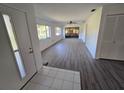 Inviting living room featuring wood-look flooring and a view of the outdoors at 12809 Wedgewood Way # A, Hudson, FL 34667