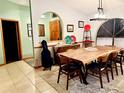The dining room features a large wood table, stylish chairs and an arched doorway to another room at 1418 Buckner Rd, Valrico, FL 33596