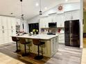 Spacious kitchen with white cabinets, granite counters, stainless steel appliances, and a central island with seating at 1418 Buckner Rd, Valrico, FL 33596
