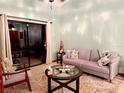 The living room features a sliding glass door, comfortable couch, and a cozy rug at 1418 Buckner Rd, Valrico, FL 33596
