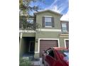 View of the two-story townhouse with a well-maintained lawn and a parked car out front at 1438 Mallory Sail Pl, Brandon, FL 33511