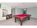 Game room featuring a red pool table, bar, and cue rack at 16717 Myrtle Sand Dr, Wimauma, FL 33598