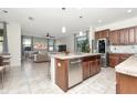 Open concept kitchen with stainless steel appliances, tile floors and center island at 16717 Myrtle Sand Dr, Wimauma, FL 33598