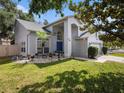 Attractive home with a blue front door, lush green lawn, and well-kept landscaping at 1830 Citrus Orchard Way, Valrico, FL 33594