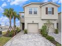 Inviting two-story home with a two-car garage, paved driveway, and well-manicured landscaping at 19153 Elsimont Isle, Lutz, FL 33558