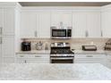 Updated kitchen with stainless oven and microwave, tile backsplash, and granite countertops at 19337 Weymouth Dr, Land O Lakes, FL 34638
