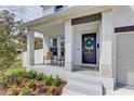 Inviting front porch with decorative wreath, seating area, and manicured landscaping at 2190 Fairway S Ave, St Petersburg, FL 33712
