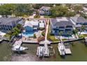 Stunning aerial view of waterfront homes with private docks and boat lifts on a sunny day at 2501 S Dundee St, Tampa, FL 33629