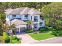 Beautiful two-story home with well-manicured lawn, mature trees, and a paver driveway at 2501 S Dundee St, Tampa, FL 33629