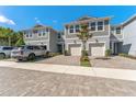 Beautiful townhome with a well-manicured front yard and a two-car driveway and garage at 2525 Arbor Wind Dr, Lutz, FL 33558