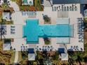 Aerial view of a community pool with ample seating, cabanas, and lush landscaping at 2525 Arbor Wind Dr, Lutz, FL 33558