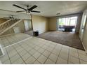 Spacious living room featuring tile floors and a staircase leading to the second floor at 2751 S Pines Dr # 10, Largo, FL 33771