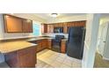 Well-equipped kitchen featuring wood cabinets, modern appliances, and a breakfast bar at 3009 S Willow Dr, Plant City, FL 33566