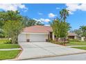 Lovely one-story house with a three-car garage, long driveway, and well-maintained lawn at 3014 Ashland Ter, Clearwater, FL 33761