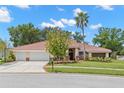 Charming single-story home with a three-car garage and mature landscaping at 3014 Ashland Ter, Clearwater, FL 33761