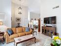 Comfortable living room with a plush leather sofa and stylish decor at 3182 Windmoor N Dr, Palm Harbor, FL 34685