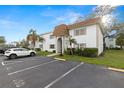 Exterior view of a white condo complex with clean parking and lawn at 343 S Mcmullen Booth Rd # 151, Clearwater, FL 33759