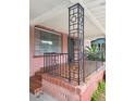 Close up of brick front porch with patterned tile flooring and iron railings at 3607 N 13Th St, Tampa, FL 33605