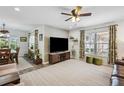 Bright living room featuring a large TV and views into the dining area at 37673 Dixie Ave, Dade City, FL 33525
