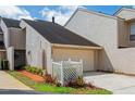 Charming home featuring a single-car garage and well-manicured landscaping at 4230 Hartwood Ln, Tampa, FL 33618